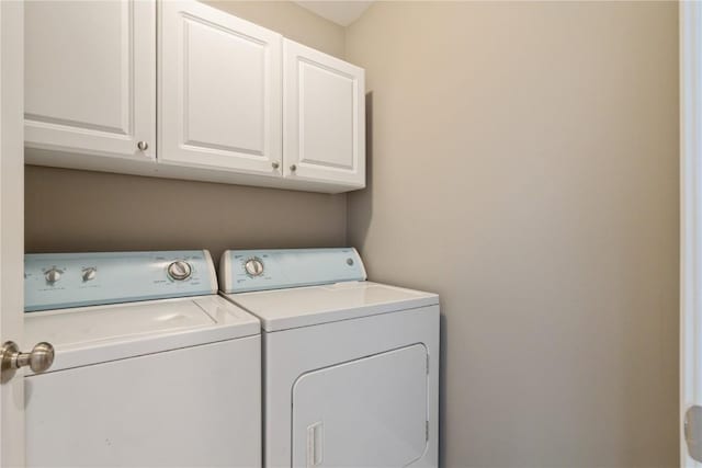 3010 Newcastle Rd, Marion, IA 52302 - laundry room featuring separate washer and dryer and cabinet space