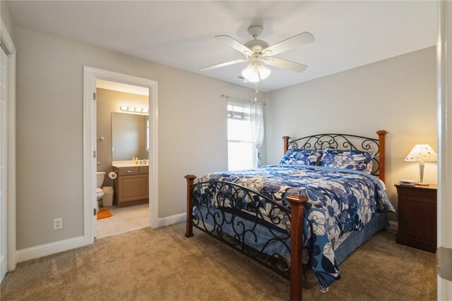 3010 Newcastle Rd, Marion, IA 52302 - bedroom with light colored carpet, ensuite bath, baseboards, and a ceiling fan