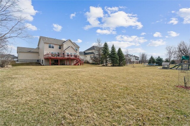 3010 Newcastle Rd, Marion, IA 52302 - view of grassy yard with a trampoline, a deck, stairs, and a playground