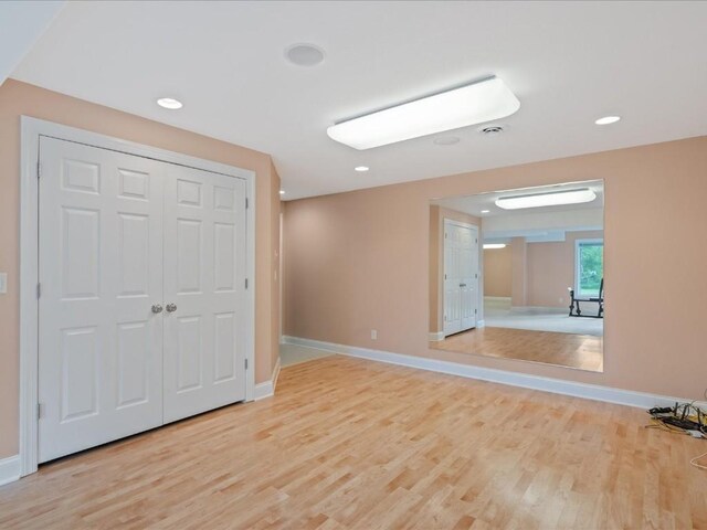 3010 Newcastle Rd, Marion, IA 52302 - unfurnished bedroom with light wood-type flooring, baseboards, a closet, and recessed lighting