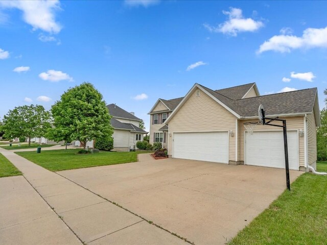 3010 Newcastle Rd, Marion, IA 52302 - view of front of home featuring concrete driveway, a garage, a front yard, and roof with shingles