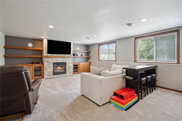 4708 Pueblo St SW, Cedar Rapids, IA 52404 - living area featuring light colored carpet, a stone fireplace, recessed lighting, and baseboards