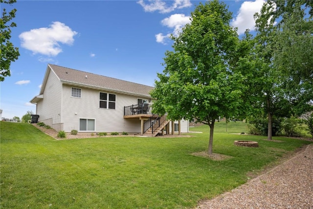 4708 Pueblo St SW, Cedar Rapids, IA 52404 - back of house with stairs, a fire pit, a deck, and a lawn