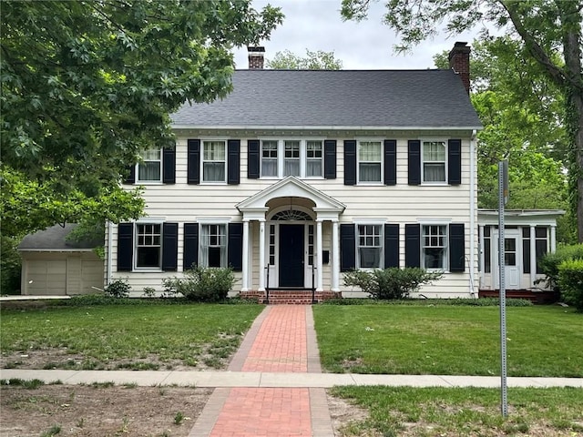 620 S Summit St, Iowa City, IA 52240 - colonial home featuring a chimney and a front lawn