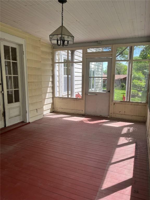 620 S Summit St, Iowa City, IA 52240 - unfurnished sunroom featuring wood ceiling and a chandelier