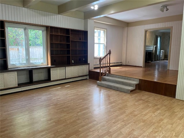 620 S Summit St, Iowa City, IA 52240 - unfurnished room featuring baseboard heating, wood finished floors, radiator heating unit, stairway, and beam ceiling