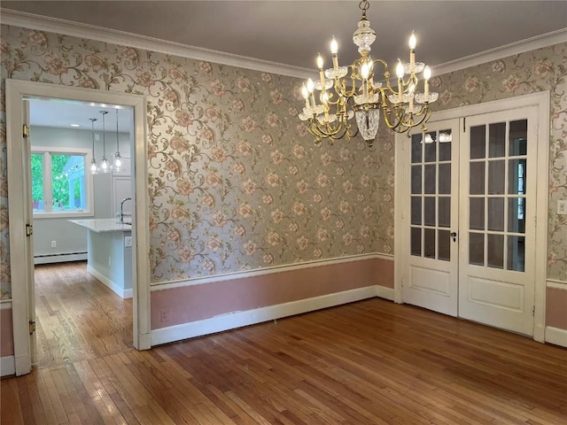 620 S Summit St, Iowa City, IA 52240 - unfurnished dining area with hardwood / wood-style flooring, a chandelier, ornamental molding, baseboards, and a baseboard radiator