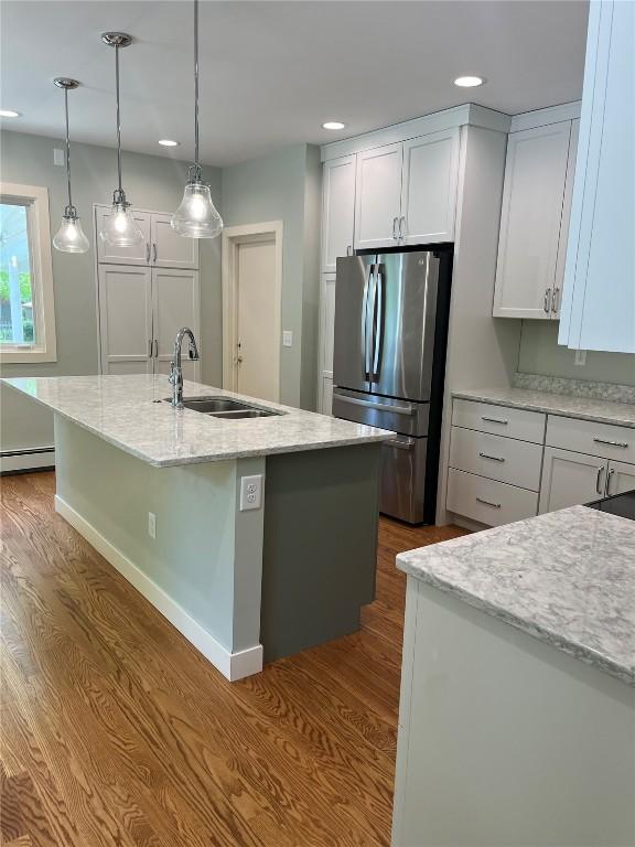 620 S Summit St, Iowa City, IA 52240 - kitchen with freestanding refrigerator, a sink, dark wood-style floors, a baseboard heating unit, and recessed lighting