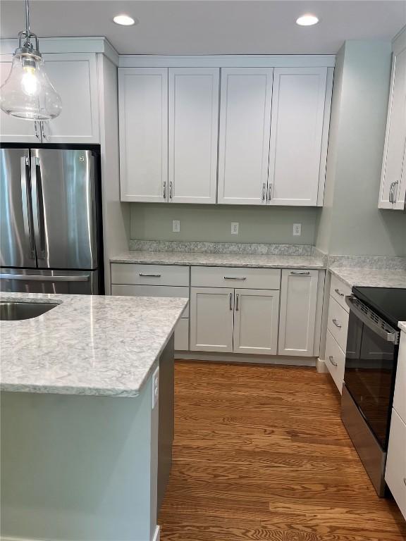 620 S Summit St, Iowa City, IA 52240 - kitchen featuring freestanding refrigerator, electric range oven, recessed lighting, pendant lighting, and white cabinetry