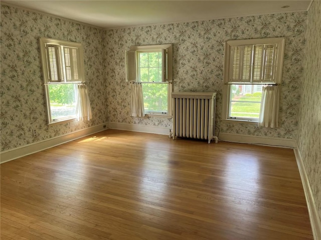 620 S Summit St, Iowa City, IA 52240 - spare room featuring radiator, hardwood / wood-style floors, baseboards, and wallpapered walls