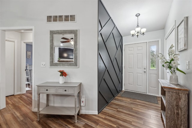 1500 Rock Island Dr, Ely, IA 52227 - entrance foyer featuring dark wood-style floors, a chandelier, baseboards, and ceiling fan