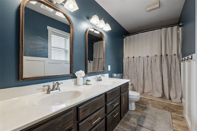 1500 Rock Island Dr, Ely, IA 52227 - full bathroom with double vanity, toilet, and a shower with shower curtain