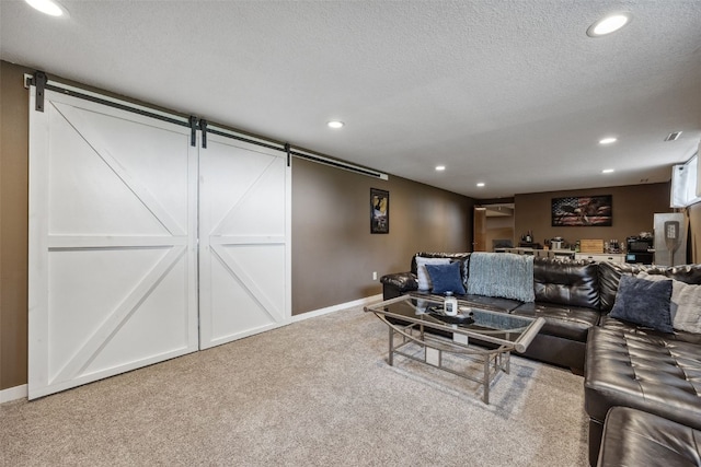 1500 Rock Island Dr, Ely, IA 52227 - cinema room featuring a barn door, carpet flooring, baseboards, recessed lighting, and a textured ceiling