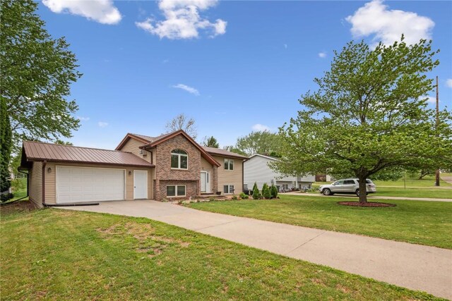 607 E Pershing Dr, Brooklyn, IA 52211 - view of front facade with a front lawn, a garage, driveway, and brick siding