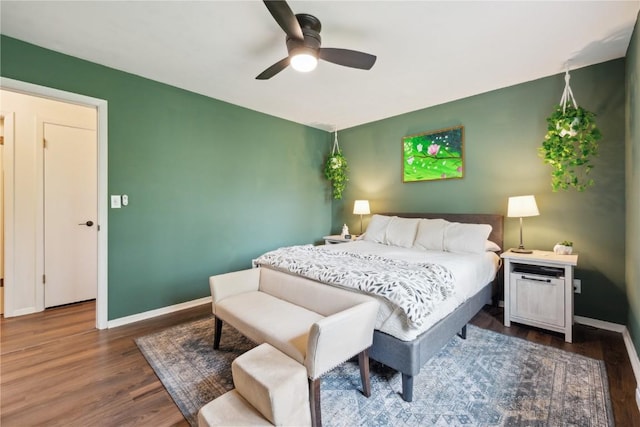 607 E Pershing Dr, Brooklyn, IA 52211 - bedroom featuring wood finished floors, baseboards, and a ceiling fan