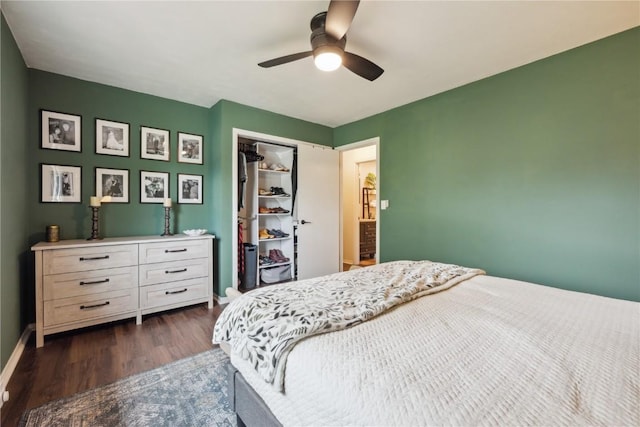 607 E Pershing Dr, Brooklyn, IA 52211 - bedroom with dark wood-style flooring, baseboards, a ceiling fan, and a closet
