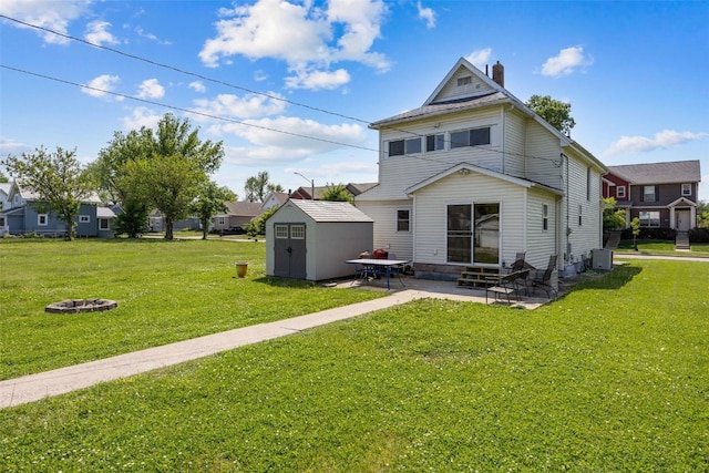 1337 Ellis Blvd NW, Cedar Rapids, IA 52405 - back of property with entry steps, a fire pit, a patio area, a chimney, and a yard