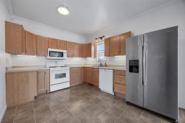 1337 Ellis Blvd NW, Cedar Rapids, IA 52405 - kitchen with white appliances, ornamental molding, light countertops, a sink, and dark tile patterned flooring