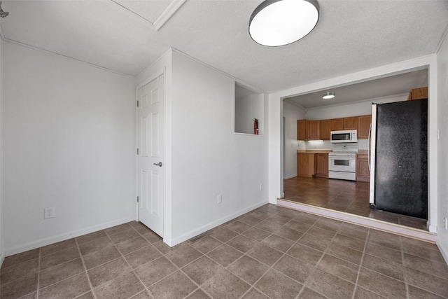 1337 Ellis Blvd NW, Cedar Rapids, IA 52405 - unfurnished living room featuring a textured ceiling, tile patterned flooring, and baseboards