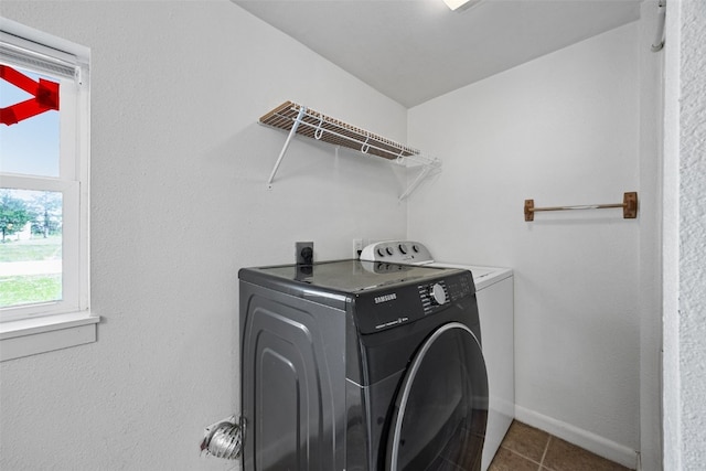 1337 Ellis Blvd NW, Cedar Rapids, IA 52405 - washroom featuring plenty of natural light, washer and clothes dryer, tile patterned flooring, and baseboards