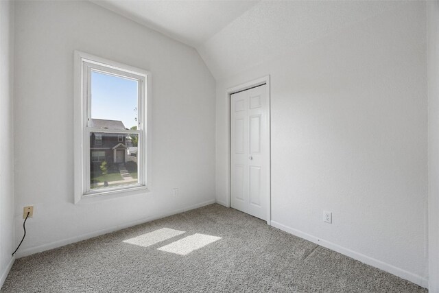 1337 Ellis Blvd NW, Cedar Rapids, IA 52405 - unfurnished bedroom with carpet, lofted ceiling, a closet, and baseboards