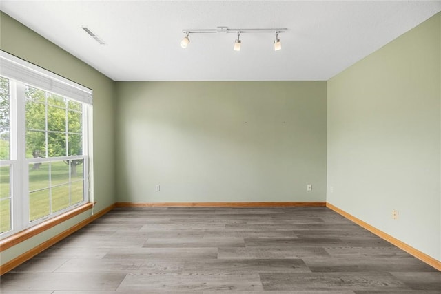 3110 Towne House Dr NE Unit C, Cedar Rapids, IA 52402 - unfurnished room with track lighting, baseboards, and wood finished floors