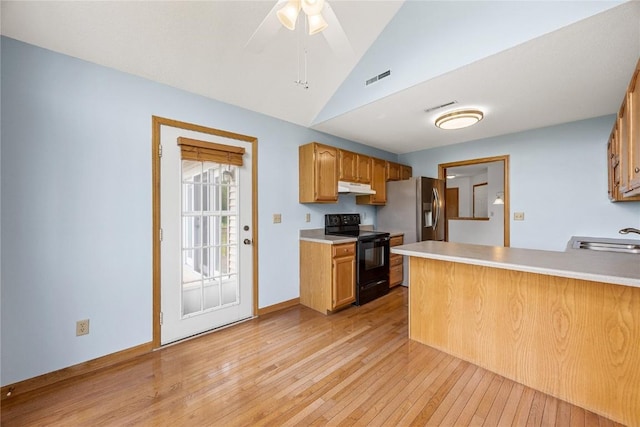 3110 Towne House Dr NE Unit C, Cedar Rapids, IA 52402 - kitchen featuring black electric range, under cabinet range hood, light wood-style floors, a peninsula, and a sink