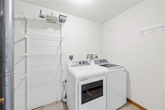 3110 Towne House Dr NE Unit C, Cedar Rapids, IA 52402 - laundry room with independent washer and dryer, a textured ceiling, and light tile patterned floors