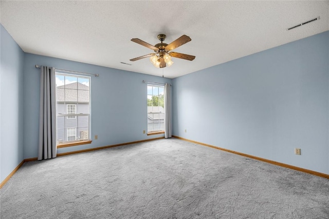 3110 Towne House Dr NE Unit C, Cedar Rapids, IA 52402 - unfurnished room with carpet flooring, a ceiling fan, baseboards, and a textured ceiling