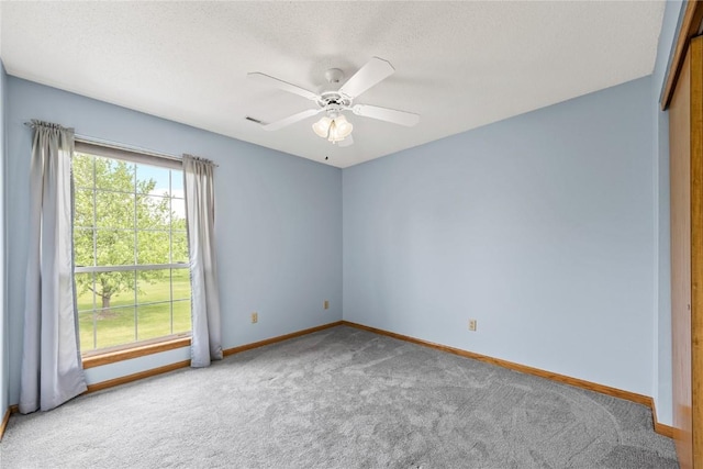 3110 Towne House Dr NE Unit C, Cedar Rapids, IA 52402 - carpeted empty room featuring baseboards, a ceiling fan, and a textured ceiling