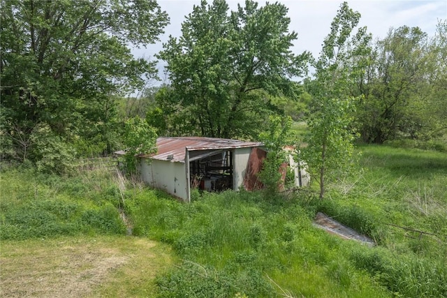 3136 155th St, Muscatine, IA 52761 - view of yard featuring an outbuilding, an outdoor structure, and a view of trees