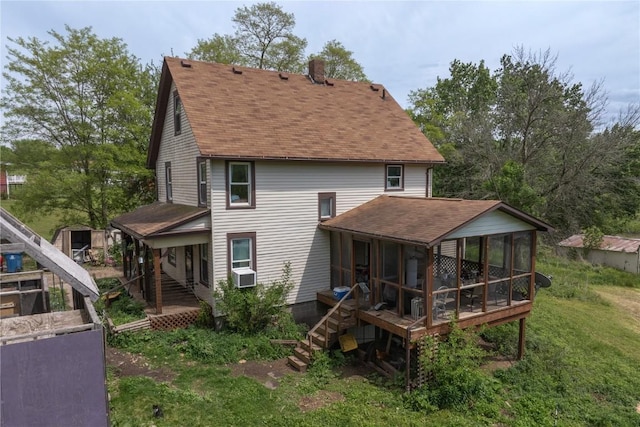 3136 155th St, Muscatine, IA 52761 - rear view of property featuring a sunroom, stairway, a chimney, roof with shingles, and cooling unit