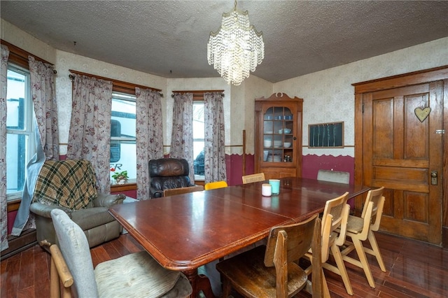 3136 155th St, Muscatine, IA 52761 - dining area featuring wood finished floors, a chandelier, and a textured ceiling