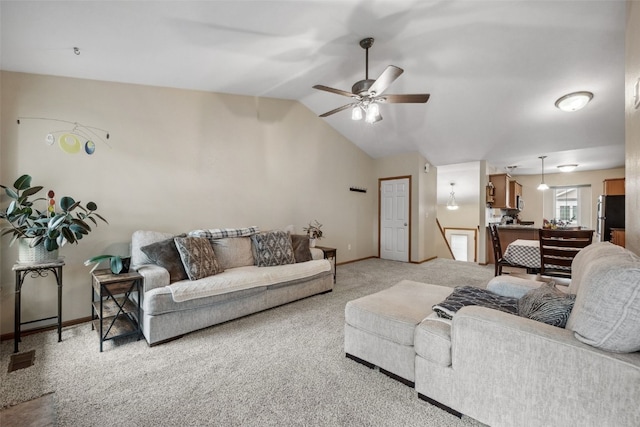 1075 Twilight Dr, North Liberty, IA 52317 - living area featuring light carpet, baseboards, a ceiling fan, and vaulted ceiling