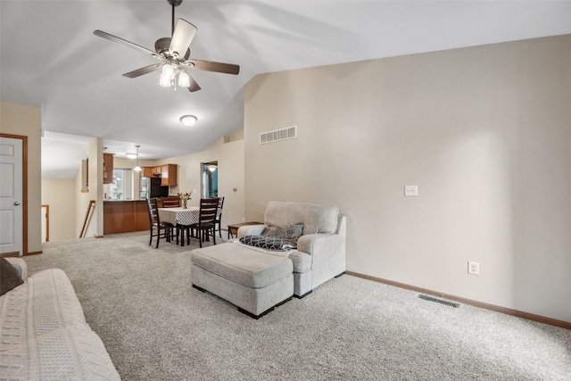 1075 Twilight Dr, North Liberty, IA 52317 - carpeted living area featuring ceiling fan, vaulted ceiling, and baseboards