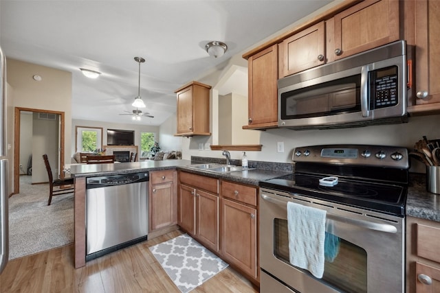 1075 Twilight Dr, North Liberty, IA 52317 - kitchen with stainless steel appliances, a sink, dark countertops, ceiling fan, and open floor plan