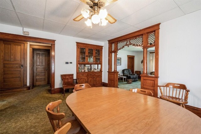 205 2nd Ave, Atkins, IA 52206 - dining room with decorative columns, ceiling fan, a drop ceiling, baseboards, and carpet flooring