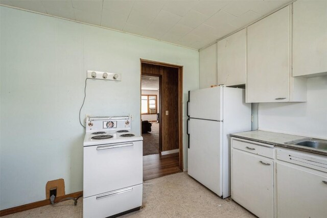 205 2nd Ave, Atkins, IA 52206 - kitchen with white appliances, light countertops, a sink, and white cabinetry