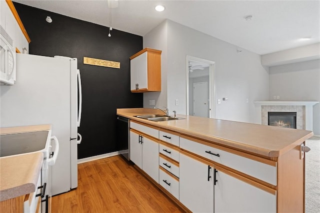 250 Cimarron Unit 311, Hiawatha, IA 52233 - kitchen with a sink, dishwashing machine, a peninsula, white electric range oven, and light wood-style flooring