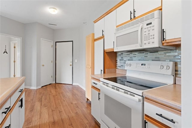 250 Cimarron Unit 311, Hiawatha, IA 52233 - kitchen featuring white appliances, light countertops, tasteful backsplash, white cabinetry, and light wood finished floors