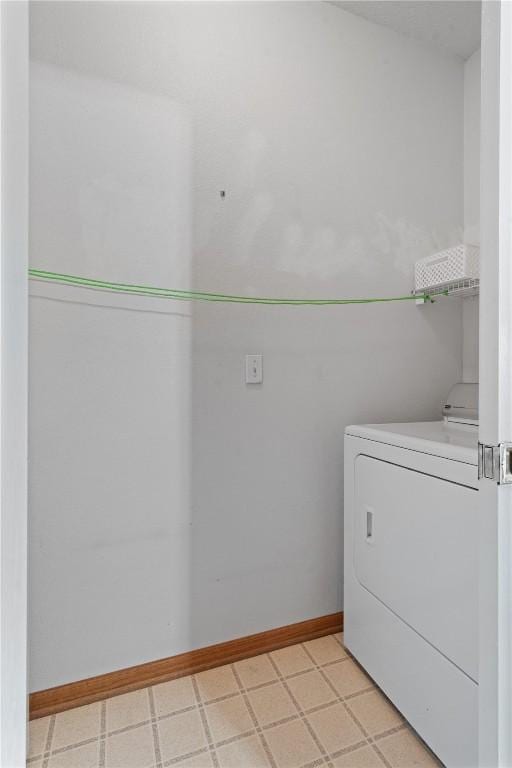 250 Cimarron Unit 311, Hiawatha, IA 52233 - laundry room featuring washer / dryer, baseboards, and light floors