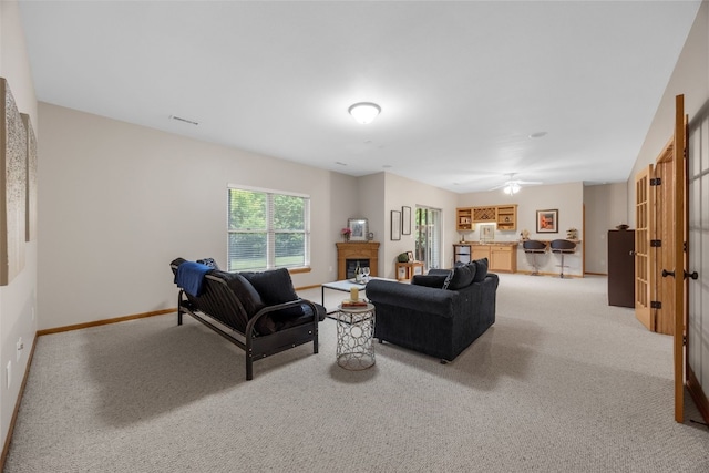 959 Tamarack Trl, Iowa City, IA 52245 - living area featuring light colored carpet, a fireplace, and baseboards