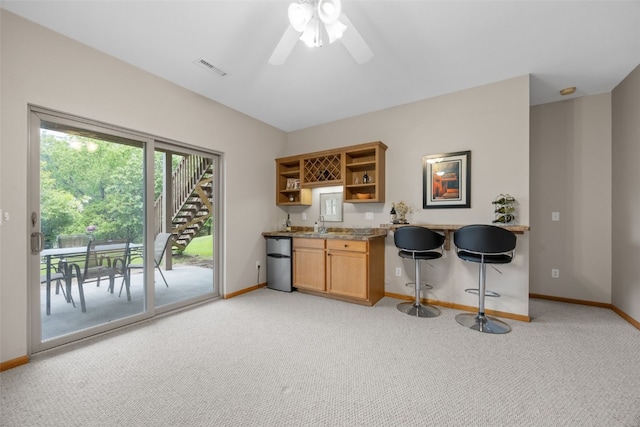 959 Tamarack Trl, Iowa City, IA 52245 - kitchen with open shelves, light carpet, baseboards, a ceiling fan, and fridge