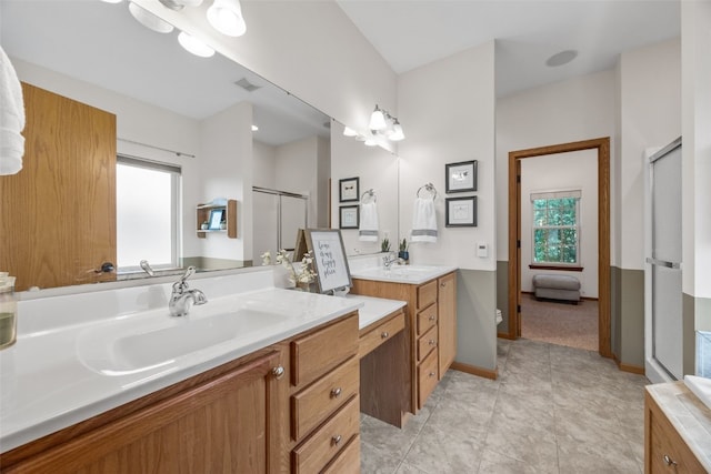959 Tamarack Trl, Iowa City, IA 52245 - full bathroom with a shower stall, two vanities, baseboards, and tile patterned flooring