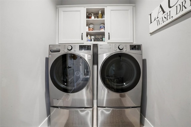 2925 Pine Hill Trce, Coralville, IA 52241 - laundry room with cabinet space, washer and clothes dryer, and baseboards