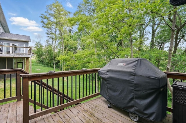 2925 Pine Hill Trce, Coralville, IA 52241 - wooden terrace featuring grilling area, a lawn, and view of wooded area