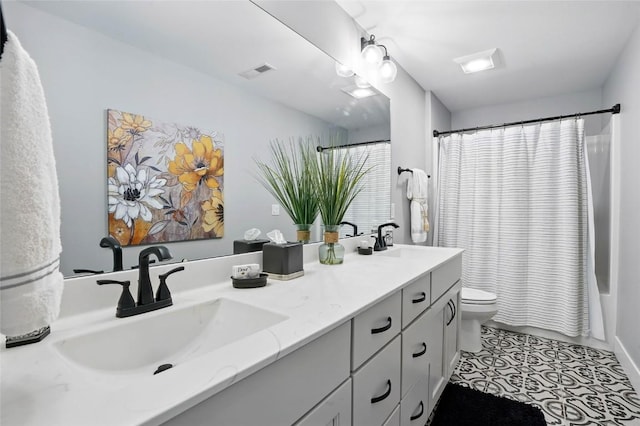 2925 Pine Hill Trce, Coralville, IA 52241 - full bath featuring double vanity, toilet, and shower / tub combo with curtain