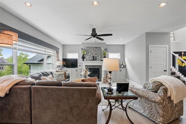 2925 Pine Hill Trce, Coralville, IA 52241 - living area with wood finished floors, a brick fireplace, ceiling fan, recessed lighting, and baseboards