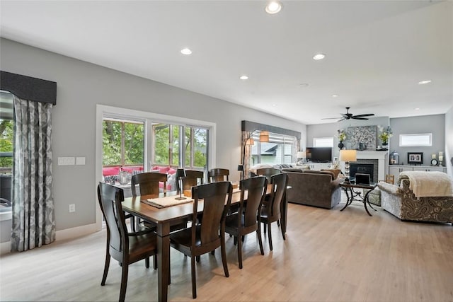 2925 Pine Hill Trce, Coralville, IA 52241 - dining area featuring recessed lighting, light wood-style floors, ceiling fan, and a glass covered fireplace
