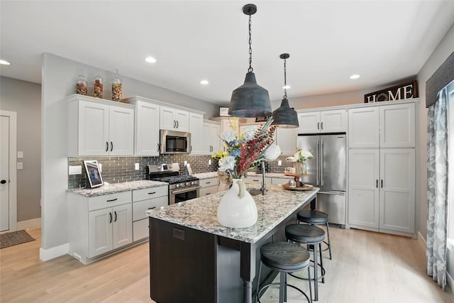 2925 Pine Hill Trce, Coralville, IA 52241 - kitchen with appliances with stainless steel finishes, light wood-style flooring, tasteful backsplash, and recessed lighting